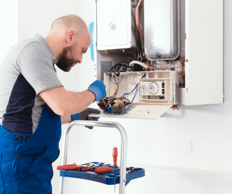 Heating engineer fixing boiler